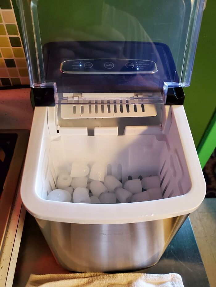 Ice maker filled with ice cubes, a convenient outdoor and backyard essential for staying cool in summer.