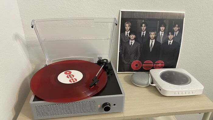 A retro-style record player with a red vinyl record and a K-pop album, a unique Prime Day electronics deal.