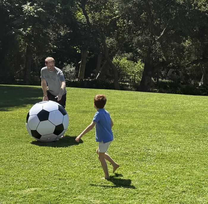 Meghan Markle's Father's Day photo showing Prince Harry and a child playing soccer with a large ball, raising parenting concerns. Meghan Markle's Father's Day photo showing Prince Harry and a child playing soccer with a large ball, raising parenting concerns.
