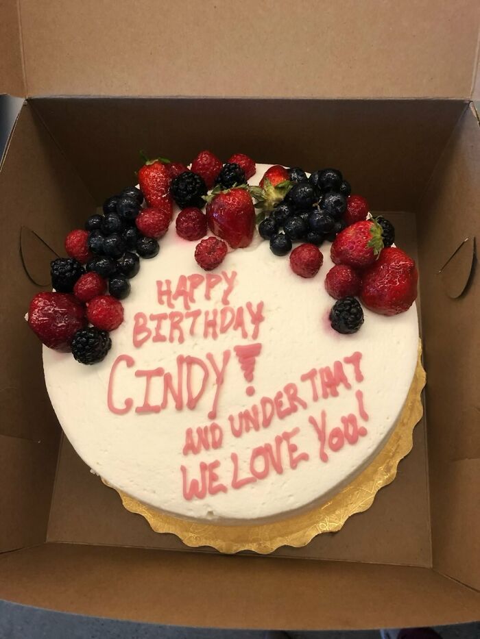 Funny cakes with hilariously messed up decorating, featuring a round cake topped with fresh berries and pink text.