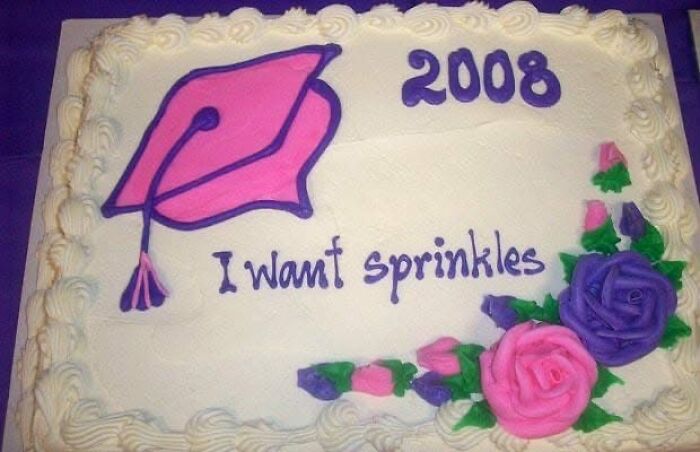 A hilariously messed up cake, a white rectangular cake with a pink graduation cap, the year 2008, and the phrase I want sprinkles.