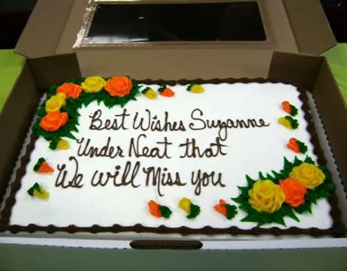 Funny cakes: A cake with the inscription Best Wishes Suzanne Under Neat that We will Miss you, showing a decorator mess up.