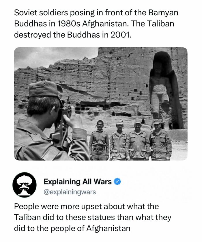 Soviet soldiers posing in front of the Bamyan Buddhas in Afghanistan, a piece of history related to wars.