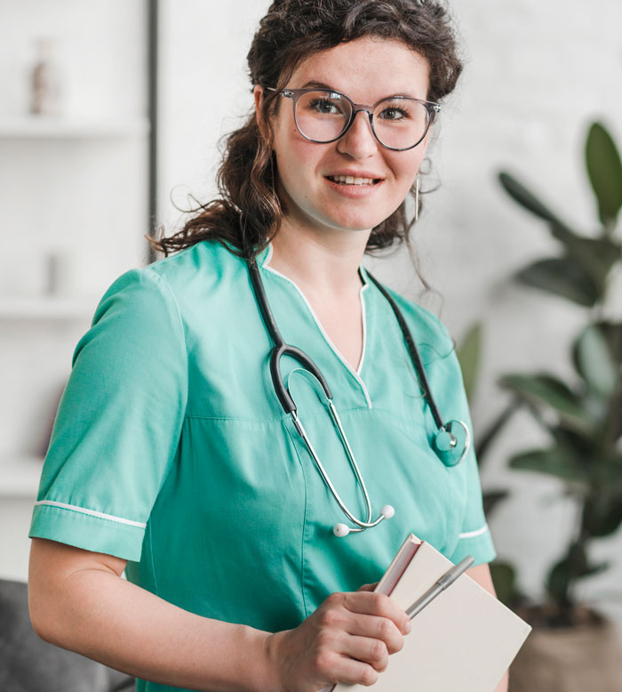 Female medical professional wearing stethoscope holding book and pen