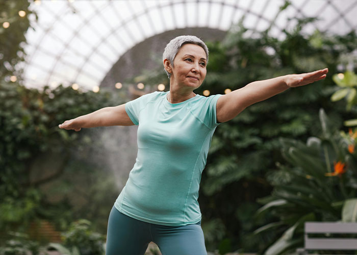 Postmenopausal woman practicing yoga for brain wellness Postmenopausal woman practicing yoga for brain wellness