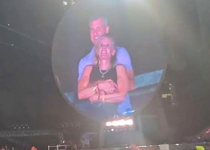 Couple embracing on stage with spotlight reflecting life moments