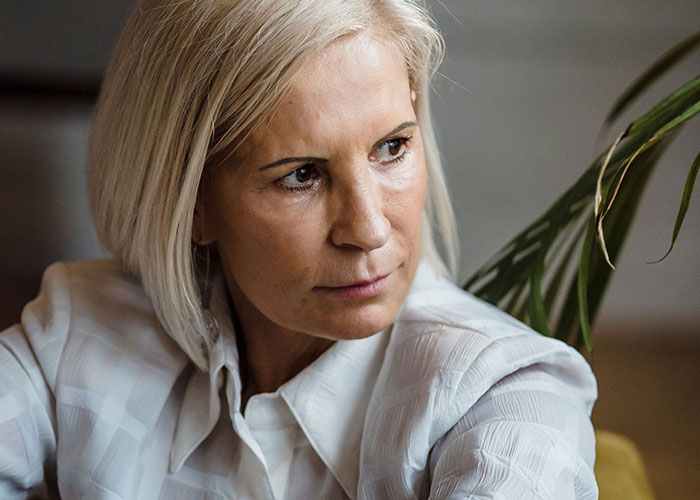 Worried middle aged woman upset by mother in law at wedding event