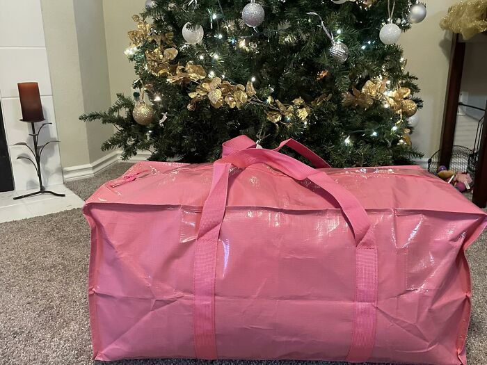 A large pink storage bag in front of a Christmas tree, ideal for home finds on Prime Day.