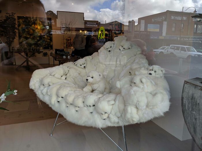 A unique couch made of many white stuffed polar bears, a piece that makes interior designers want to lie down.