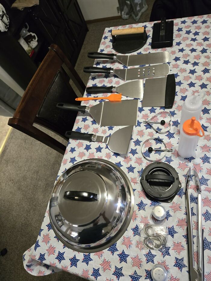 A collection of grilling tools laid out on a patriotic tablecloth, ideal last minute Fathers Day gifts.