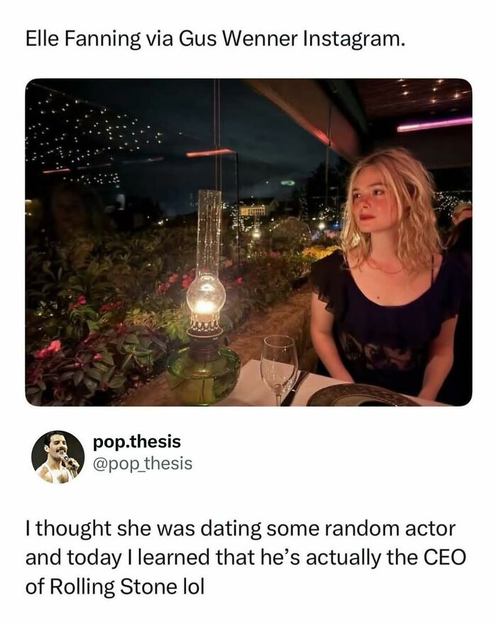 Elle Fanning sitting at a dimly lit restaurant table with an antique lantern, a fun pop culture post.
