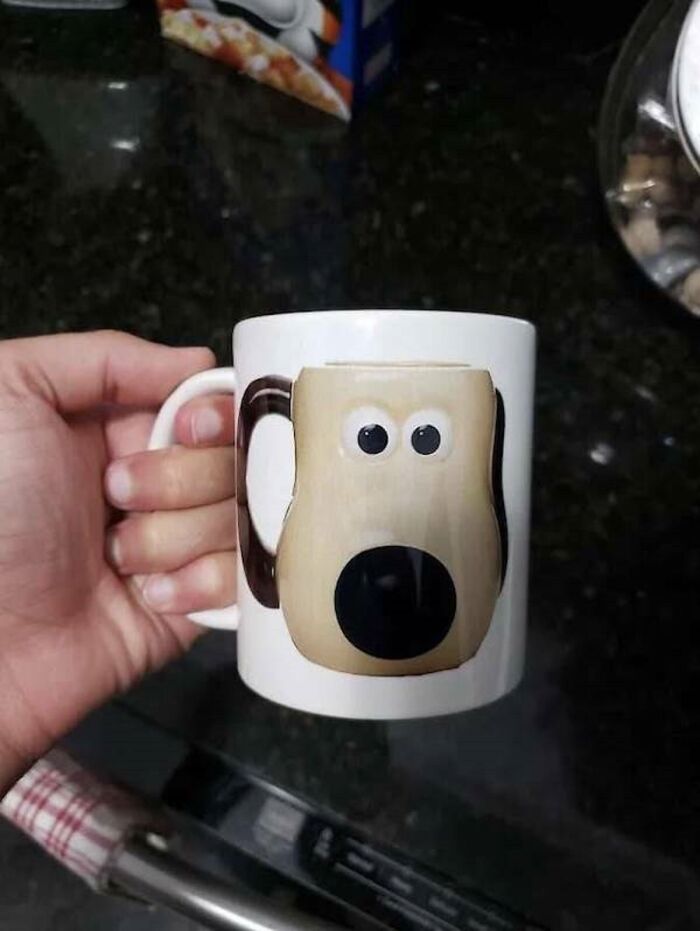 A coffee mug with a dog's face where the handle makes the ear, a ridiculous you had one job fail.