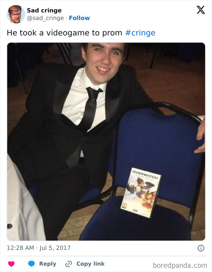 A young man in a tuxedo posing with an Overwatch game box next to him, representing something cringy posted.