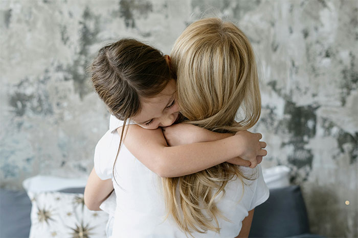 A child hugs their mother, showcasing the bond amidst a food issue that a boyfriend initially doubted.