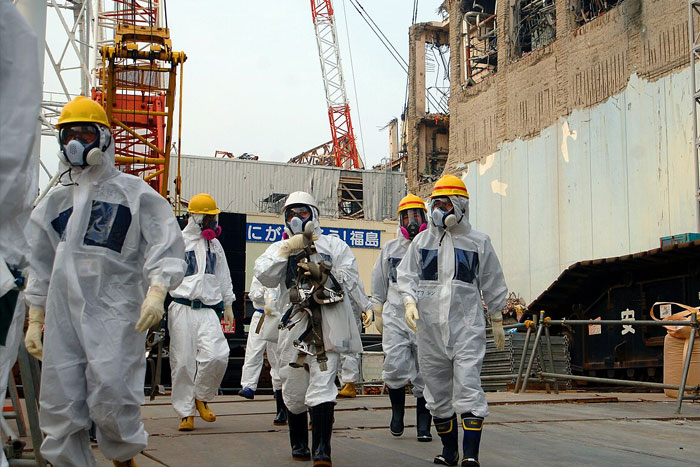 Scientists in protective gear at a nuclear disaster cleanup site