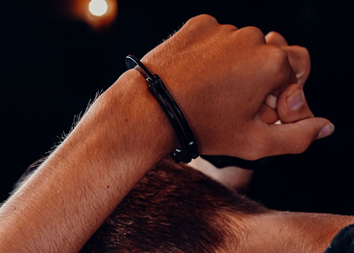 Close-up of hands bound by handcuffs symbolizing criminal restraint