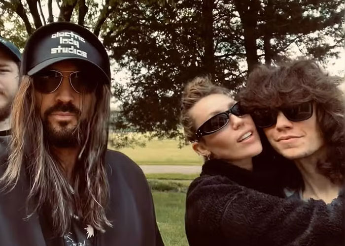 Three people outdoors wearing sunglasses including Miley Cyrus Three people outdoors wearing sunglasses including Miley Cyrus