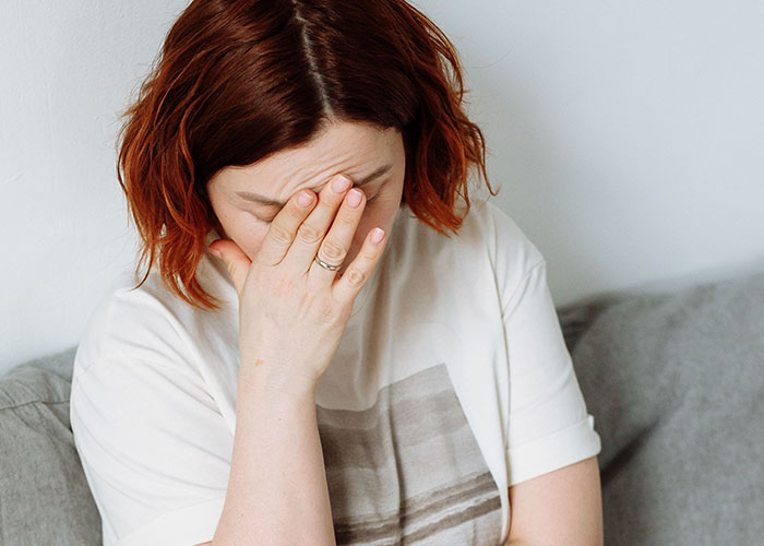 Stressed woman covering face showing wedding anxiety