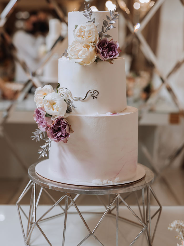 Elegant three-tier wedding cake decorated with flowers