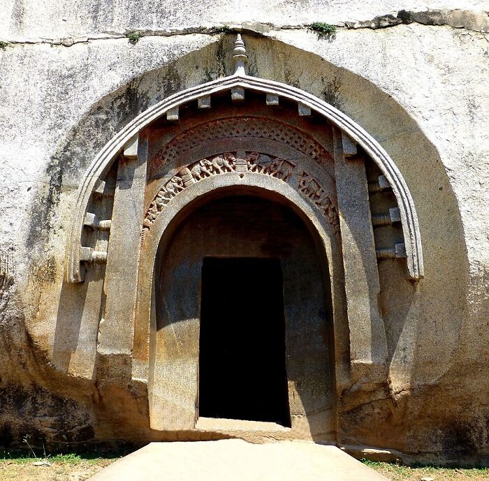 An ancient rock-cut cave entrance, a site of unsolved mysteries and historical unexplained events.
