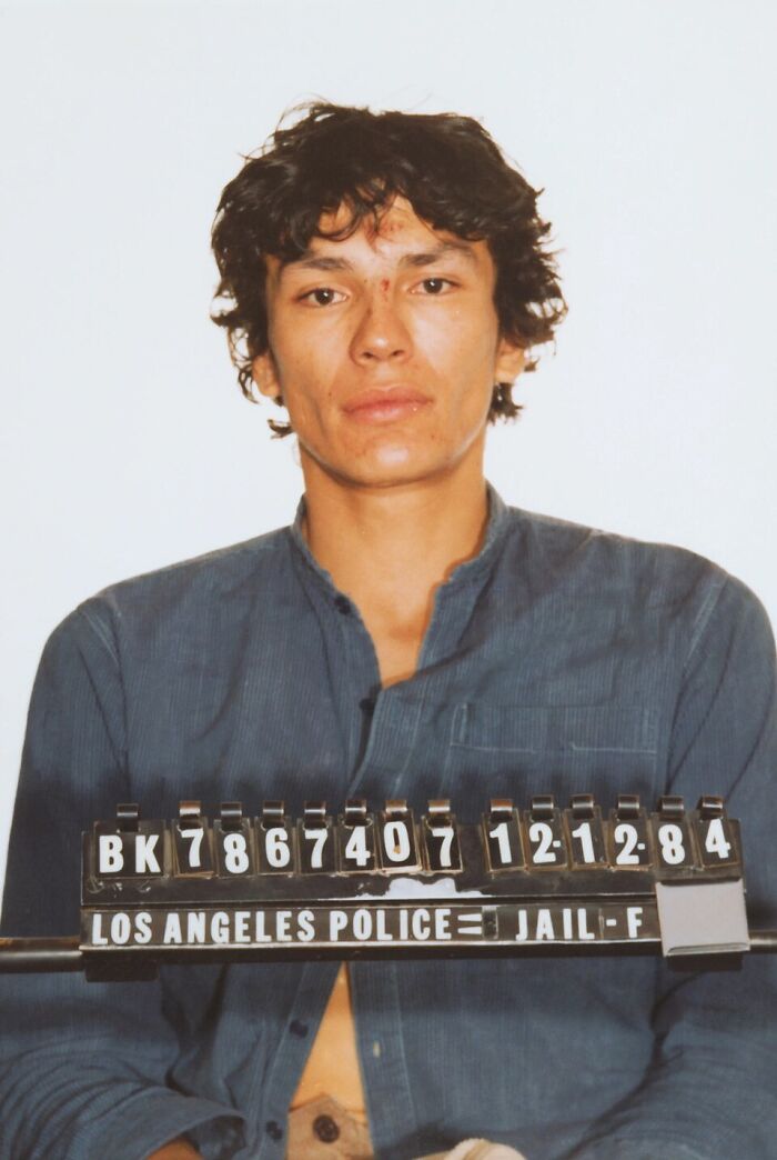 Mugshot of male serial killer in blue shirt by Los Angeles Police