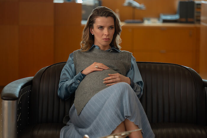 Pregnant woman sitting seriously in office scene from Office Romance Pregnant woman sitting seriously in office scene from Office Romance