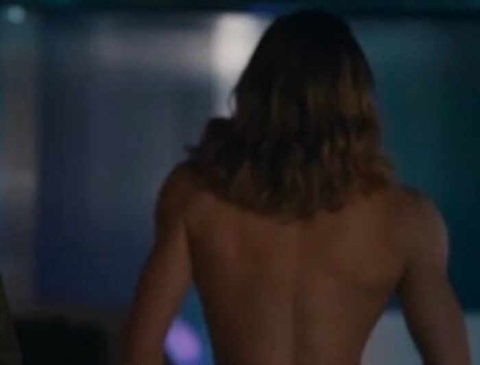 Shirtless AMC show star with long hair, seen from behind, showcasing his muscular back to fans.