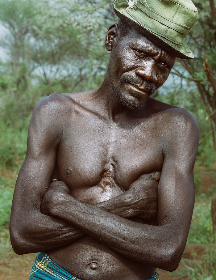 Shirtless man with a hat in nature, embodying strength and raw beauty of the human spirit