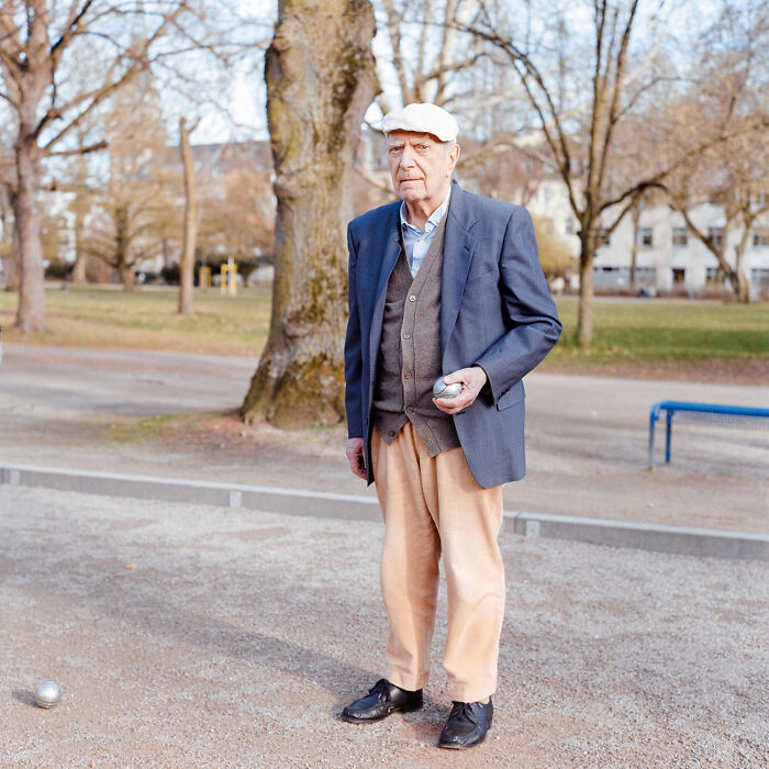 Elderly man playing boules in the park showing the raw beauty of the human spirit