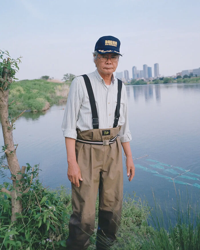 Portrait of an elderly man fishing by the river, exemplifying the human spirit