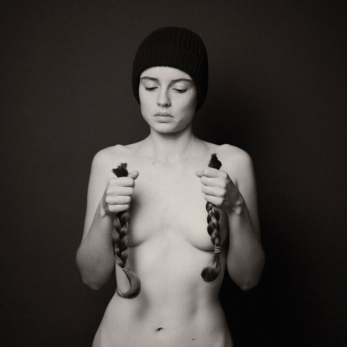 Black and white portrait of a woman holding braided hair symbolizing raw human spirit