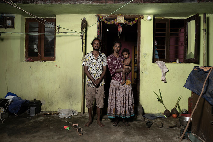 Family portrait standing in front of home exemplifying raw beauty of human spirit