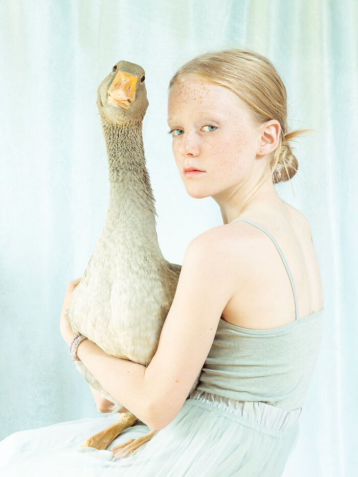 Young girl holding a goose in a portrait of human spirit beauty