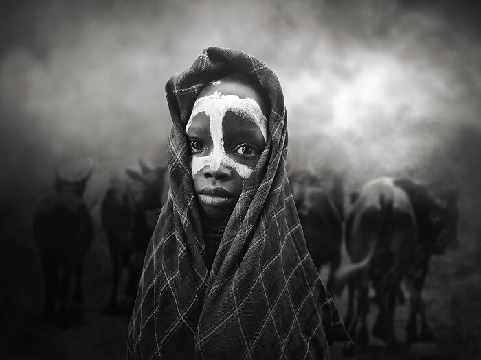 Black and white portrait of child with face paint representing raw beauty of human spirit