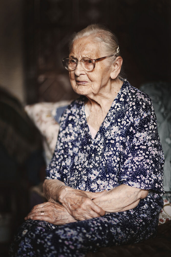 Portrait of elderly woman showing raw beauty of human spirit with glasses and floral dress