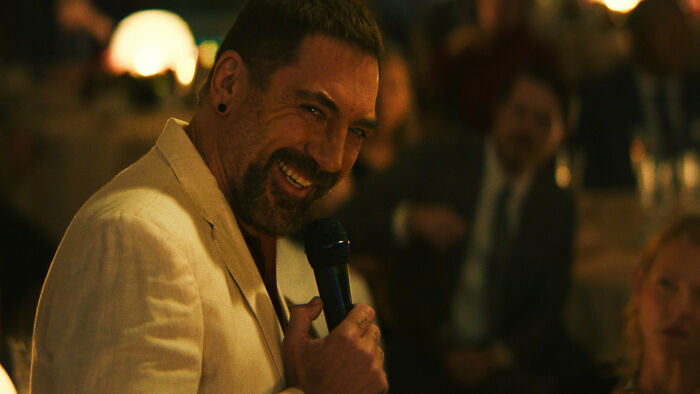 Cape Fear villain smiling with microphone at event