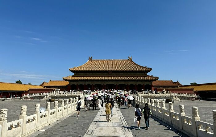 The grand Forbidden City in China, bustling with tourists under a clear sky, an unforgettable experience for any traveler.
