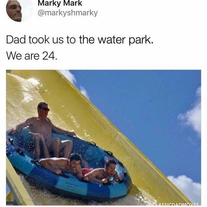 Three men, including a father and his adult sons, smile while riding a water slide together on an inner tube, soul-healing.