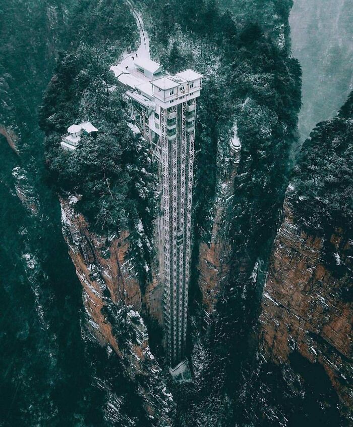 The Bailong Elevator, Built Into A Cliff Face In Zhangjiajie, China. Rising 1070 Feet Tall, It's The Highest Outdoor Elevator In The World. It Can Reach The Mountain Peak In 2 Minutes