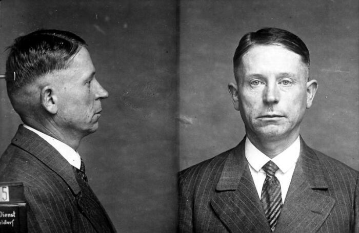 Vintage mugshot of a serial killer in formal suit