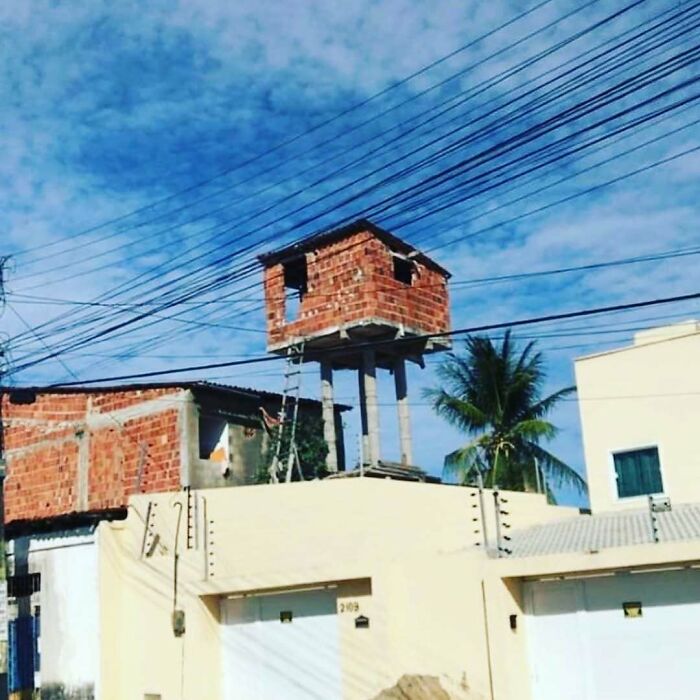 A small, incomplete brick structure perched high on pillars, an example of architecture and design fails.