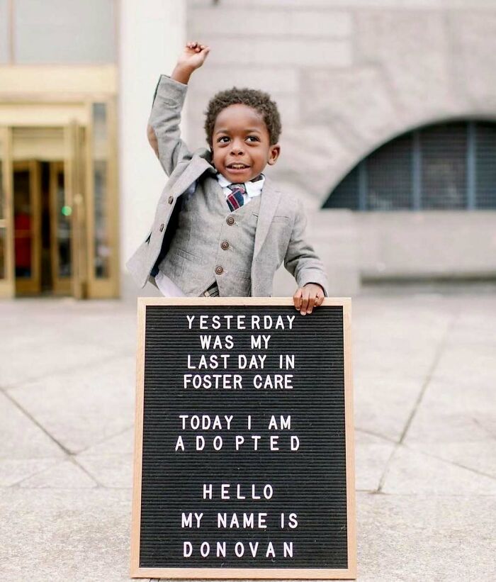 Soul-healing celebration: A young boy joyfully announces his adoption with a sign, marking his last day in foster care.