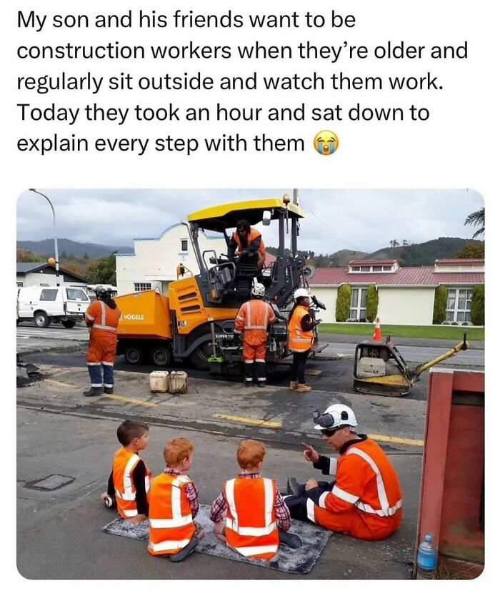 Construction workers in orange vests and hard hats explain their work to three young boys, a soul-healing interaction.