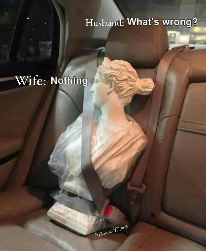 Funny husband and wife meme with statue in car seatbelt