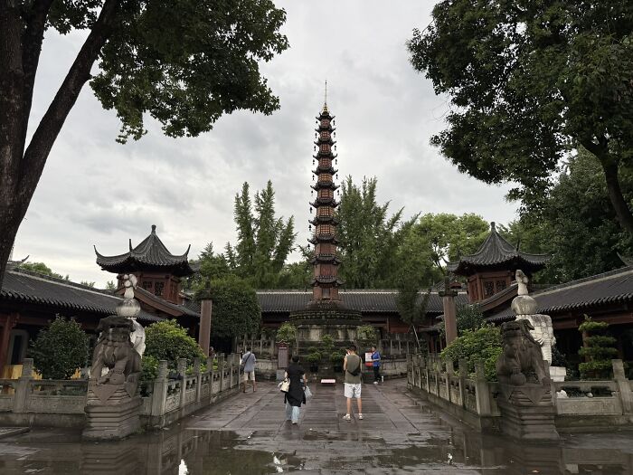 A traditional pagoda temple complex in China surrounded by lush greenery, offering a serene experience for a traveler.