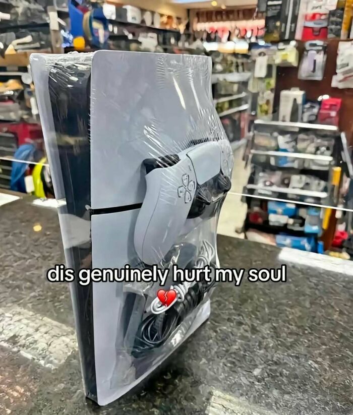 PlayStation 5 wrapped with controller and cables in plastic packaging humor