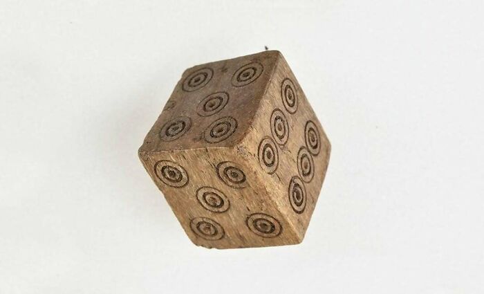 Old wooden dice with engraved dots historical treasure