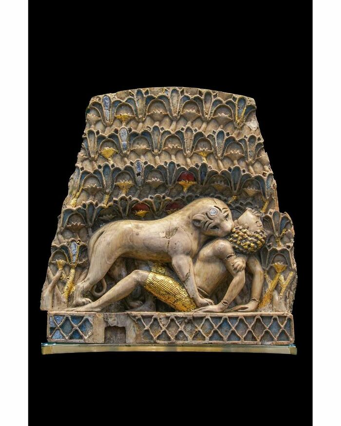 Ancient ivory relief sculpture of lion attacking a man historical treasure