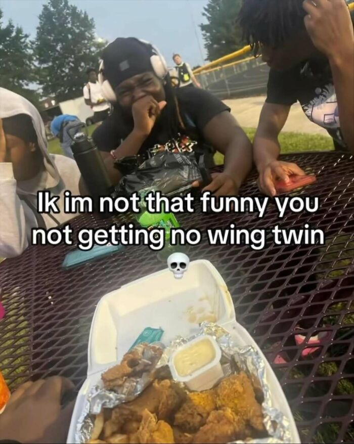 Group of friends laughing with funny chicken wings meme