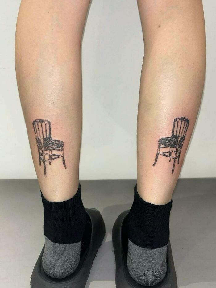 A tattoo artist's talent is seen in matching chair tattoos on a person's calves, a questionable idea.